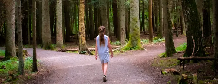 A girl faces a fork in the road