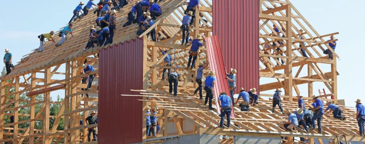 team building a wooden house